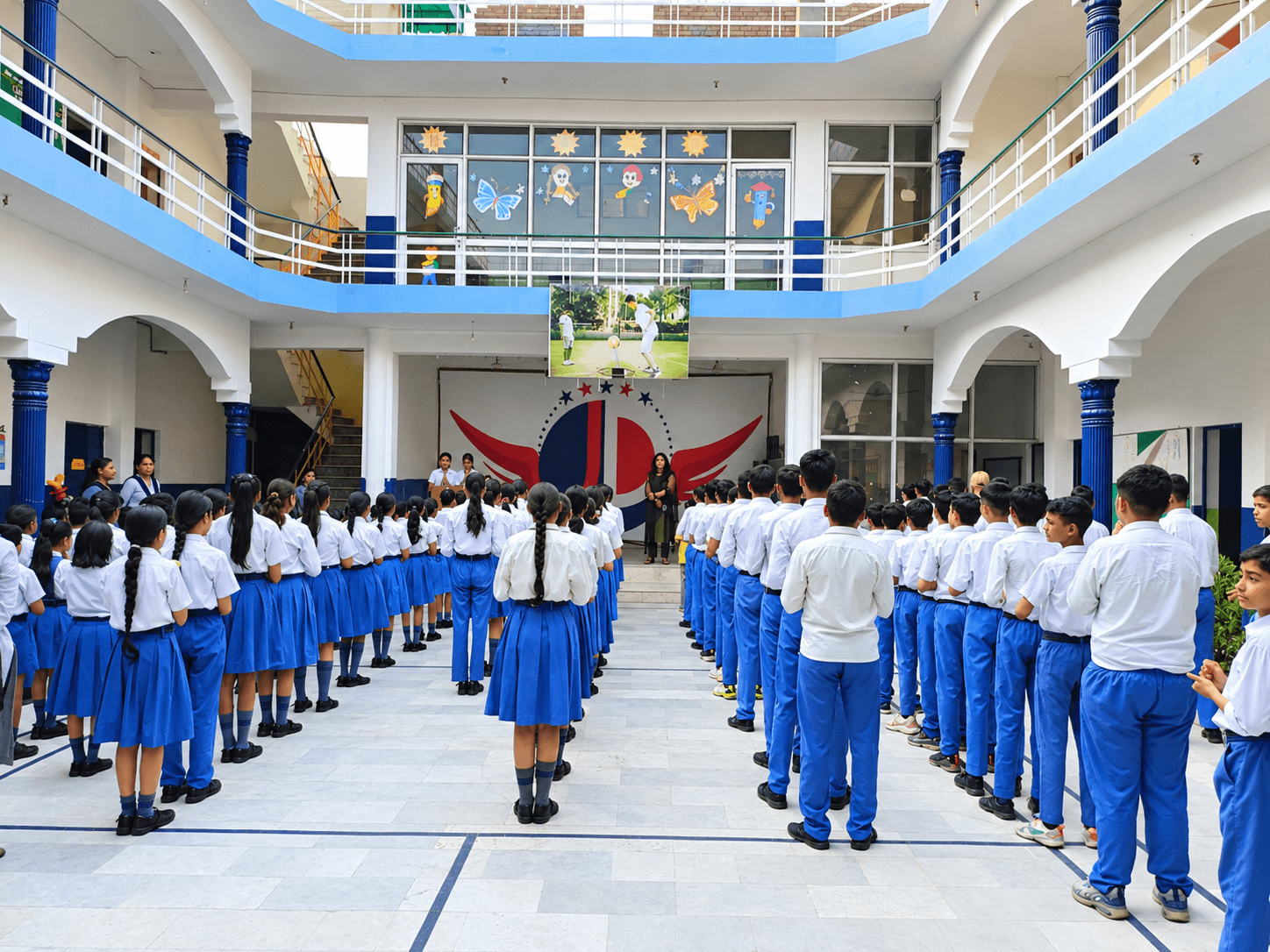 Students assembled in uniform for morning assembly in the school atrium environment
